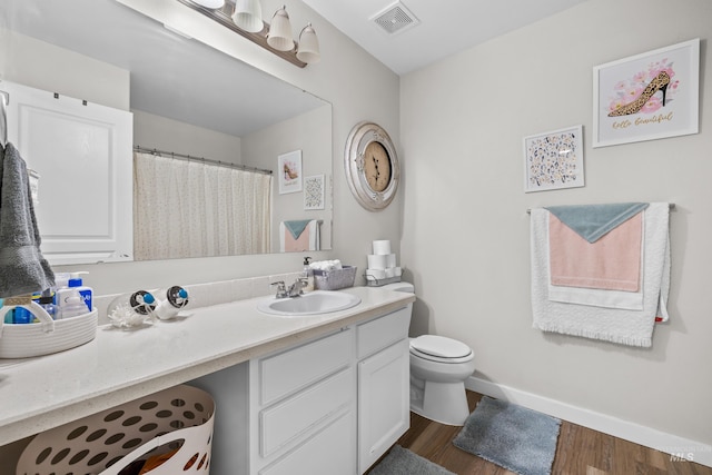 2145 W Quilceda, Kuna, ID 83634 - full bath with wood finished floors, vanity, toilet, baseboards, and curtained shower