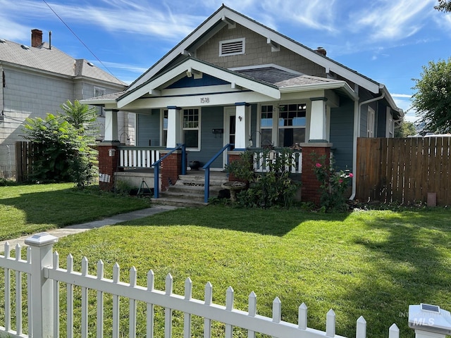 view of front of house featuring covered porch and a front lawn