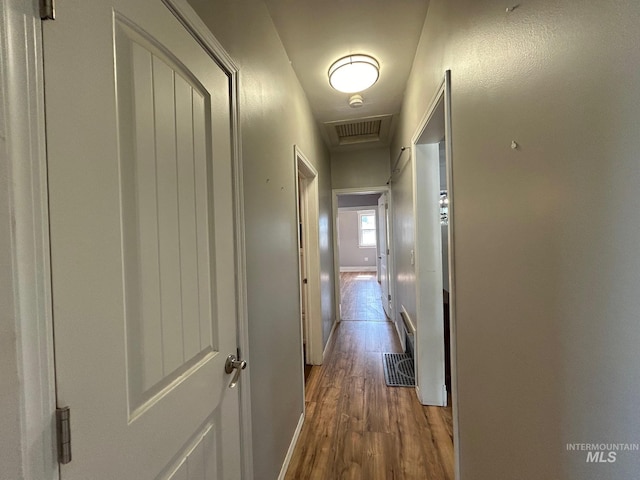 corridor featuring dark hardwood / wood-style flooring