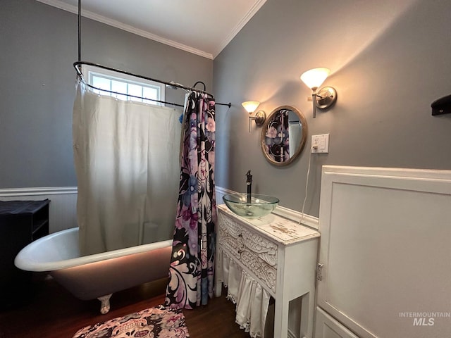 bathroom featuring crown molding, sink, and hardwood / wood-style floors