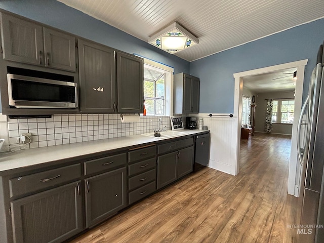 kitchen with sink, plenty of natural light, light hardwood / wood-style floors, and appliances with stainless steel finishes