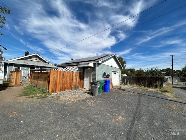 view of front of house with solar panels and a garage