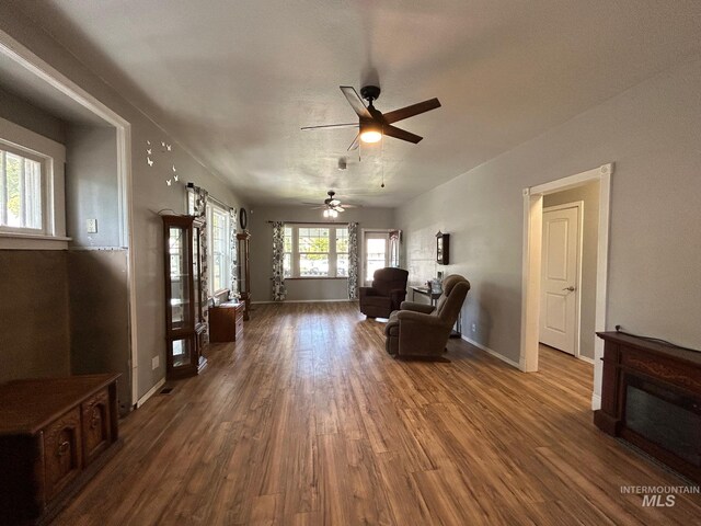 living area with hardwood / wood-style flooring and ceiling fan