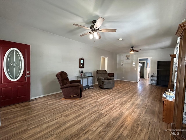 sitting room with ceiling fan and dark hardwood / wood-style flooring