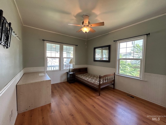 unfurnished bedroom with light hardwood / wood-style floors, ceiling fan, and ornamental molding