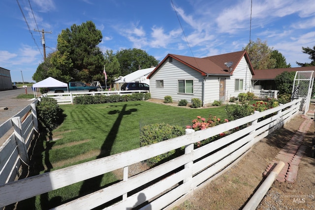 view of property exterior featuring fence, a gazebo, and a lawn