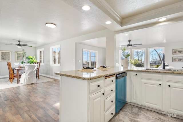 kitchen with sink, white cabinetry, dishwasher, and crown molding