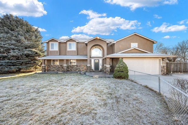 view of front of property featuring a front lawn and a garage