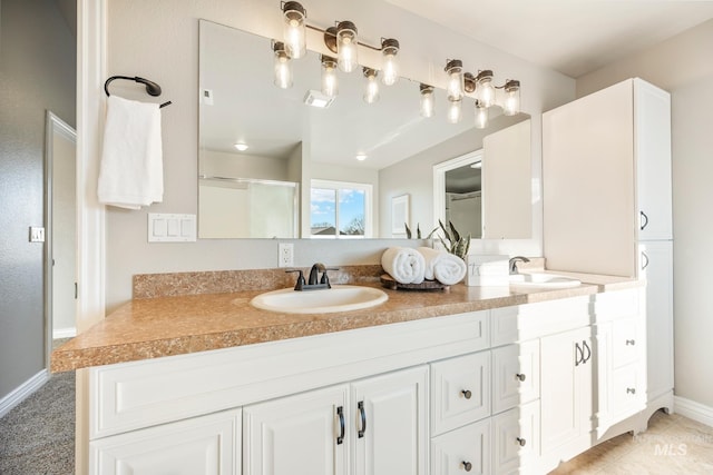 bathroom featuring walk in shower and vanity