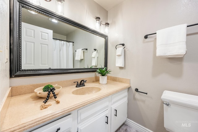 bathroom with toilet and vanity