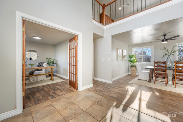 entryway featuring ceiling fan and light tile patterned floors