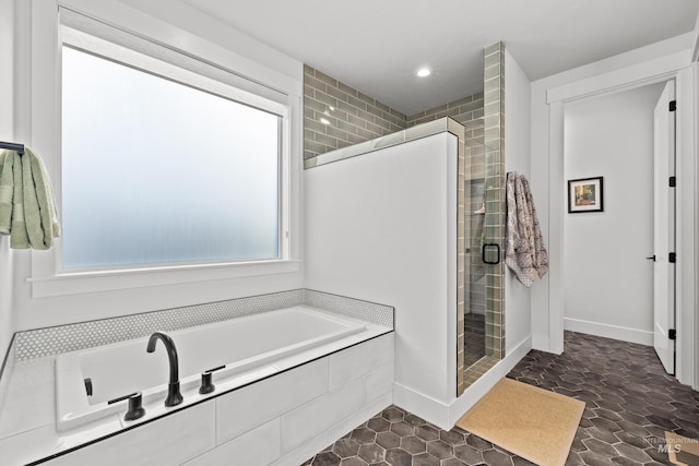 bathroom with separate shower and tub