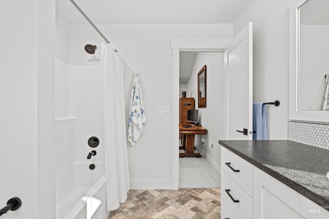 bathroom featuring backsplash, vanity, and shower / bath combo