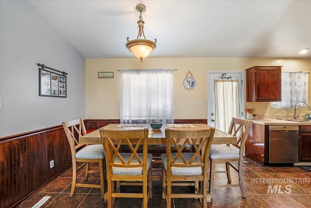 206 Diamond Dr, Kimberly, ID 83341 - dining space featuring wainscoting, dark stone finish flooring, and wooden walls