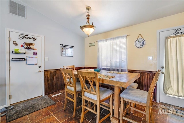 206 Diamond Dr, Kimberly, ID 83341 - dining area featuring lofted ceiling, wainscoting, and wooden walls