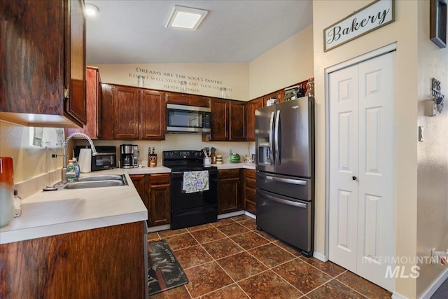 206 Diamond Dr, Kimberly, ID 83341 - kitchen featuring stainless steel appliances, a sink, lofted ceiling, light countertops, and dark tile patterned flooring