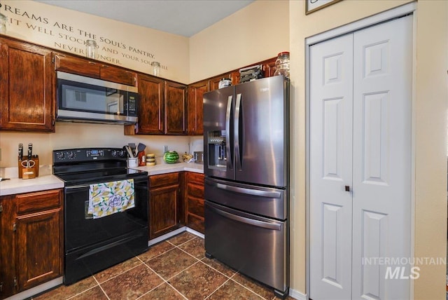206 Diamond Dr, Kimberly, ID 83341 - kitchen with appliances with stainless steel finishes, light countertops, dark tile patterned flooring, and dark brown cabinets