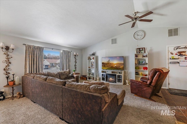 206 Diamond Dr, Kimberly, ID 83341 - carpeted living room featuring lofted ceiling, ceiling fan, a glass covered fireplace, and baseboards