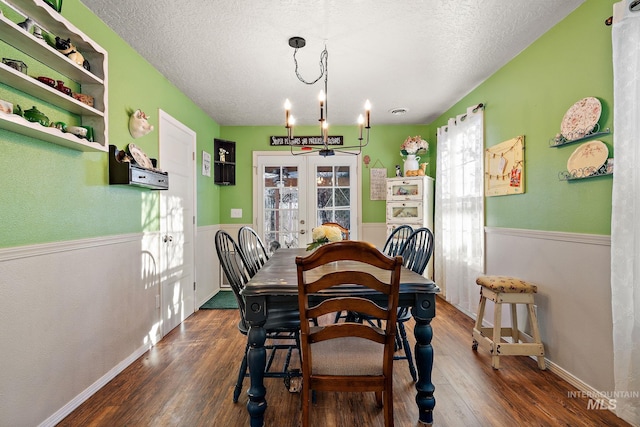 dining space with french doors, dark hardwood / wood-style floors, and a textured ceiling