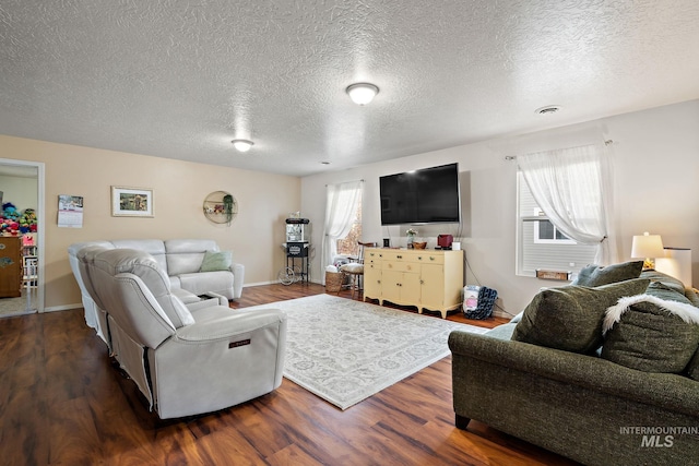 living room with dark wood-type flooring and a textured ceiling