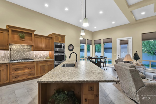 kitchen with appliances with stainless steel finishes, a sink, brown cabinetry, decorative backsplash, and open shelves