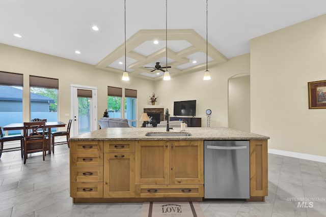 kitchen featuring stainless steel dishwasher, a sink, light marble finish floors, a fireplace, and ceiling fan