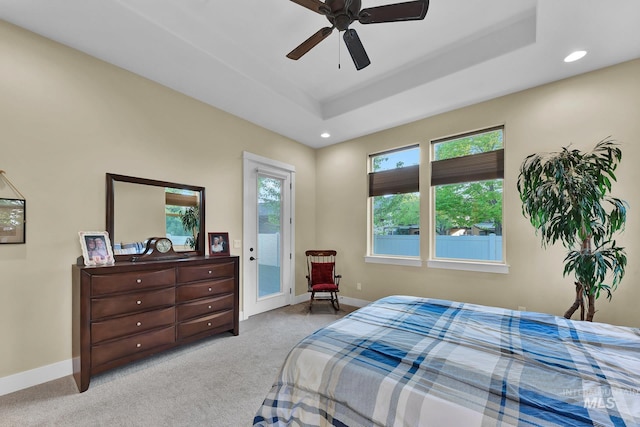 carpeted bedroom featuring access to outside, recessed lighting, baseboards, a raised ceiling, and ceiling fan