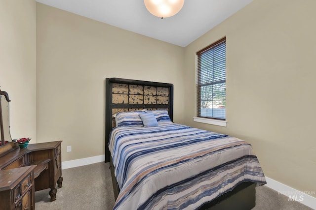carpeted bedroom featuring baseboards