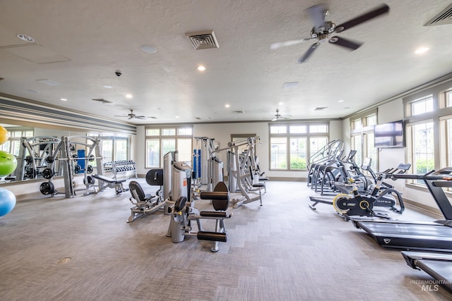 gym featuring a ceiling fan, plenty of natural light, carpet flooring, recessed lighting, and a textured ceiling