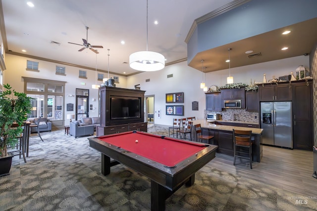 recreation room featuring ornamental molding, ceiling fan, a high ceiling, billiards, and recessed lighting