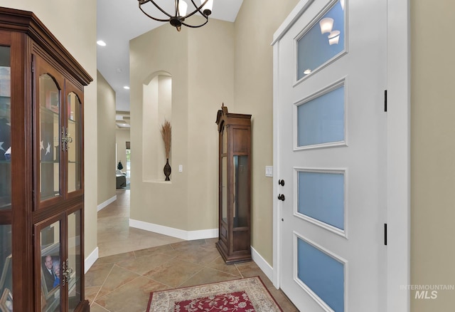 entryway with baseboards, a chandelier, and recessed lighting