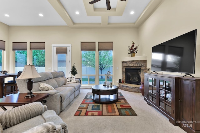 living area with a ceiling fan, carpet flooring, a stone fireplace, and recessed lighting