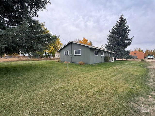 view of side of home featuring a yard