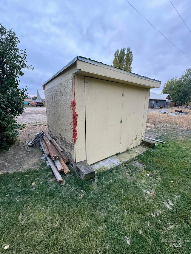 view of outbuilding with a lawn