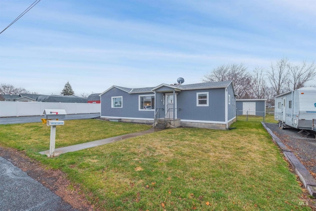 view of front of property with a front lawn and fence