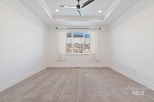 carpeted empty room featuring baseboards, a raised ceiling, a ceiling fan, and recessed lighting