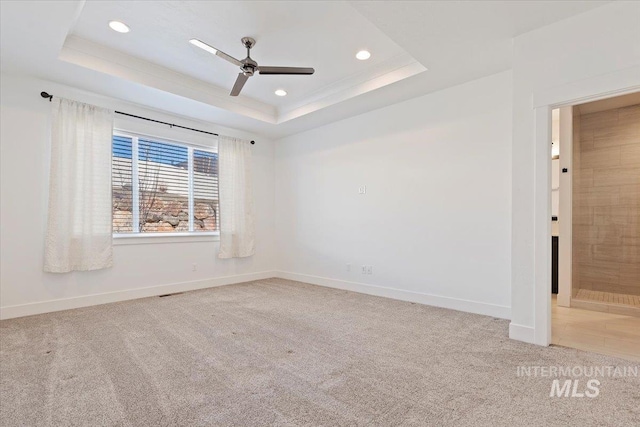 unfurnished room with baseboards, a raised ceiling, carpet flooring, and recessed lighting