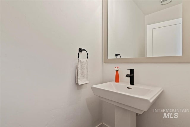 bathroom featuring visible vents and a sink