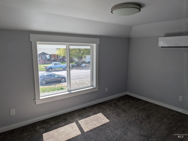unfurnished room featuring a wealth of natural light, baseboards, a wall unit AC, and dark carpet