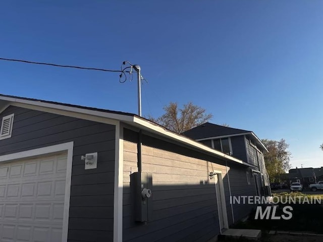 view of side of property with a garage