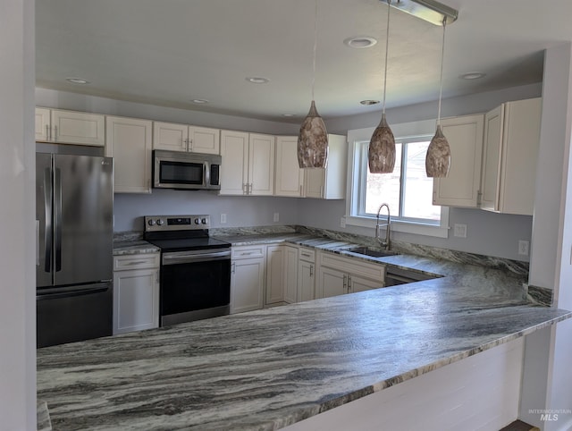 kitchen featuring a sink, light stone countertops, white cabinets, and appliances with stainless steel finishes