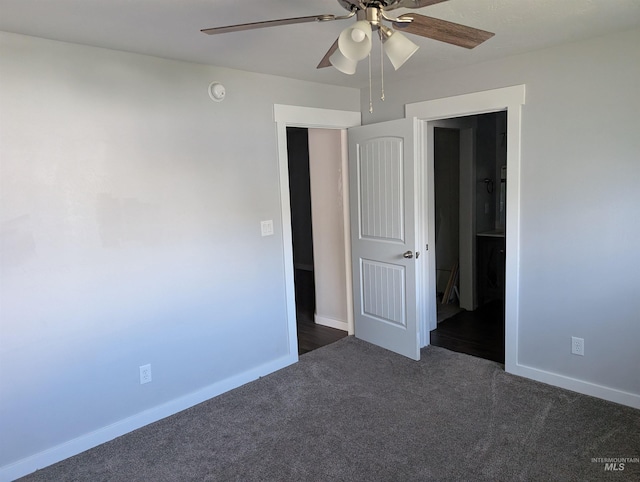 unfurnished bedroom featuring baseboards, a ceiling fan, and dark carpet