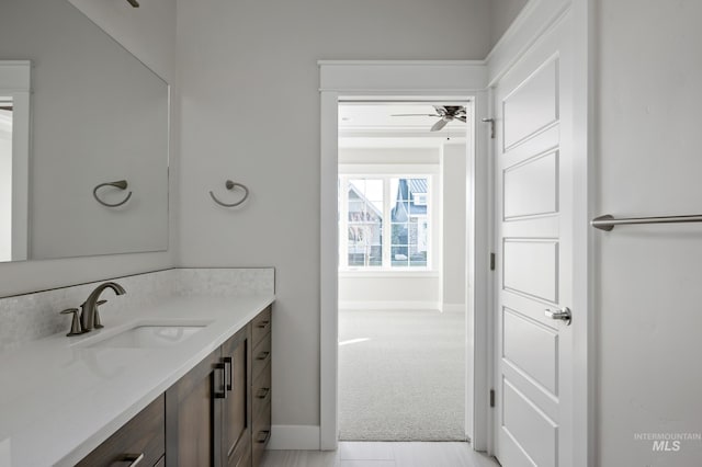 bathroom with ceiling fan, baseboards, and vanity