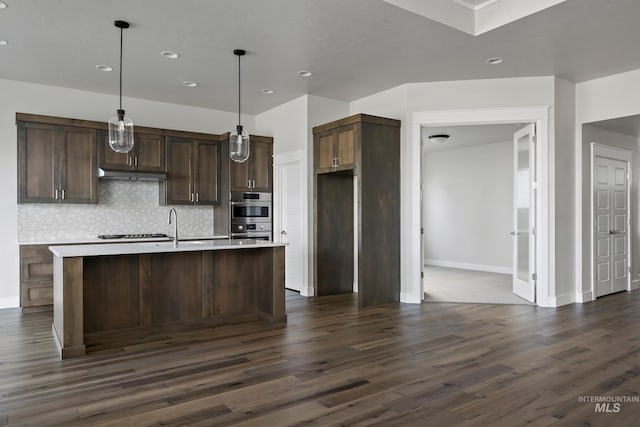 kitchen featuring light countertops, dark wood-type flooring, and tasteful backsplash
