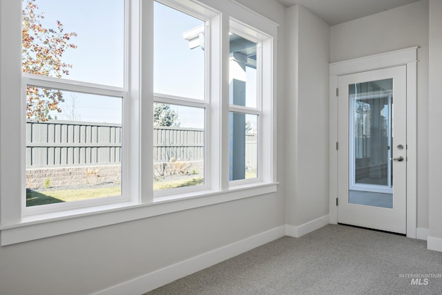 interior space featuring carpet and baseboards