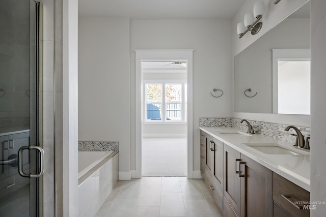 full bath featuring a shower stall, double vanity, tiled tub, and a sink