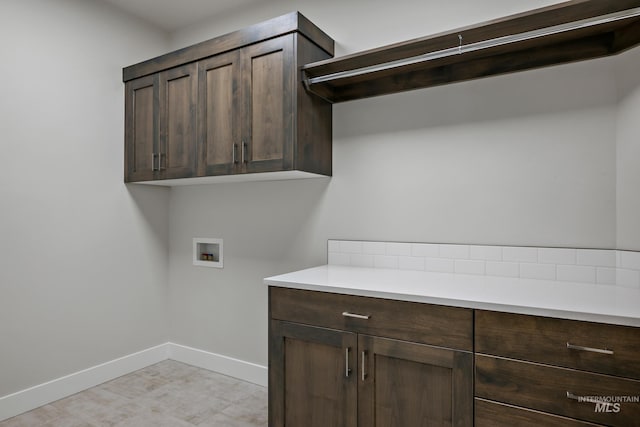laundry area featuring cabinet space, washer hookup, and baseboards