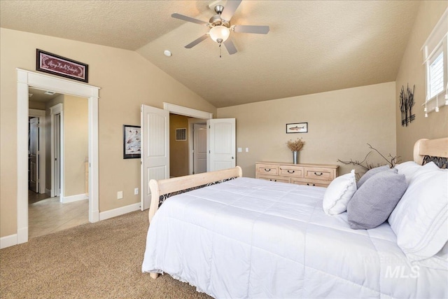 bedroom featuring light carpet, lofted ceiling, a textured ceiling, baseboards, and ceiling fan