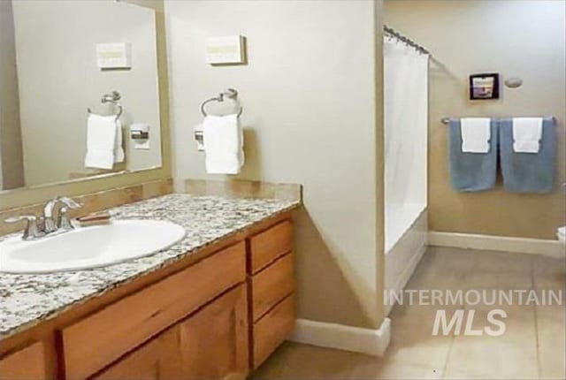 full bath featuring vanity and tile patterned flooring