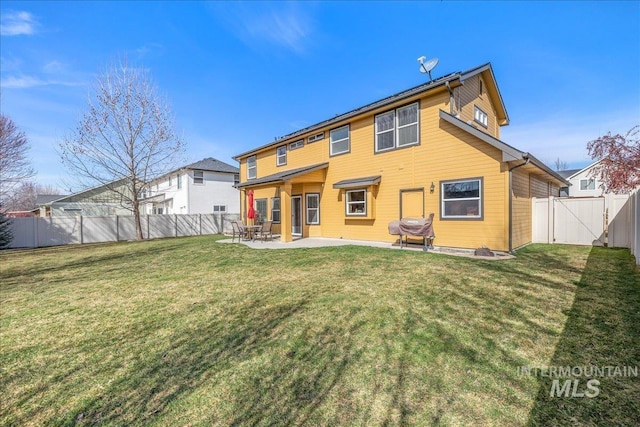 rear view of property with a gate, a lawn, a fenced backyard, and a patio area